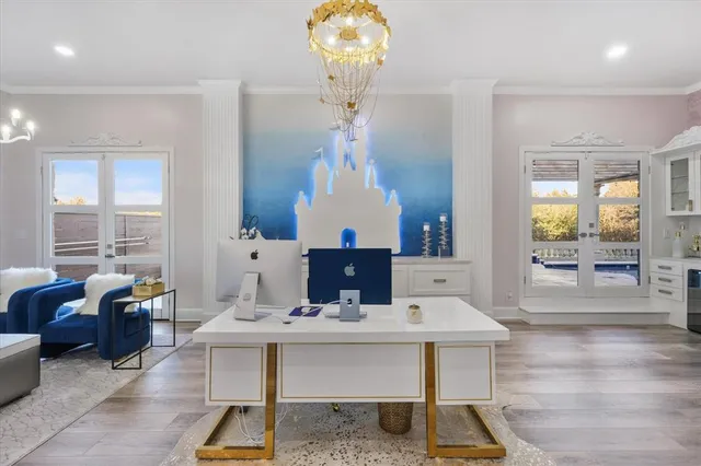 a living room with dining table and a chandelier