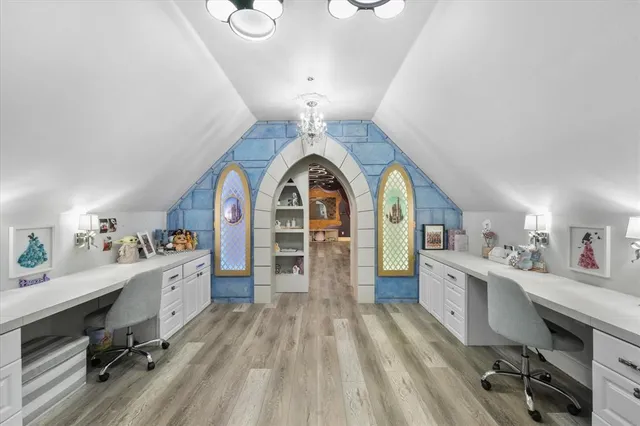 a view of a kitchen with fridge and wooden floors