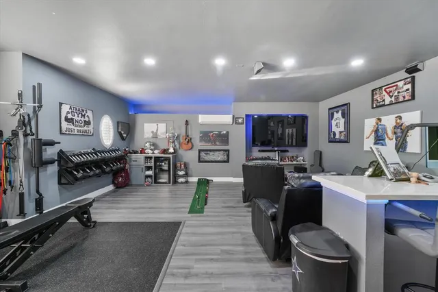 a living room with lots of furniture and view of kitchen