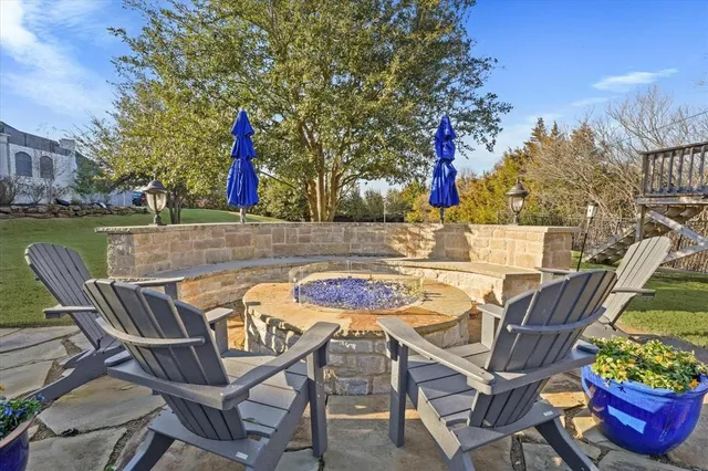 a view of a chairs and table in patio