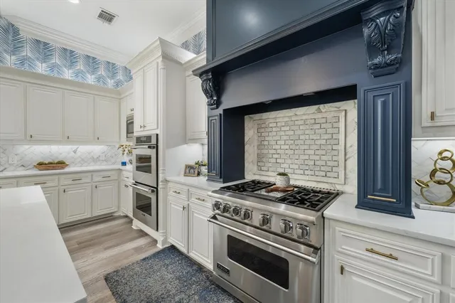 a kitchen with cabinets appliances and a window
