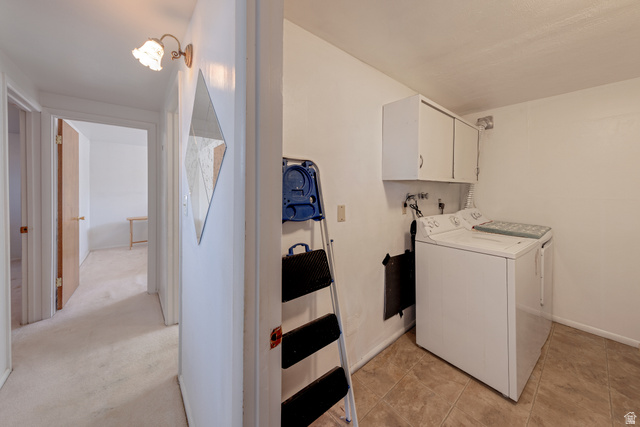 738 Locust Lane Moab, UT 84532 - Photo 18 of 25 Laundry area featuring washer and dryer and cabinet space