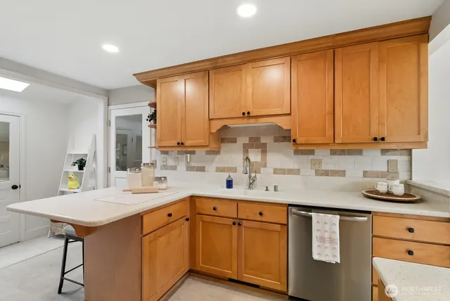 a kitchen with a sink stove and cabinets