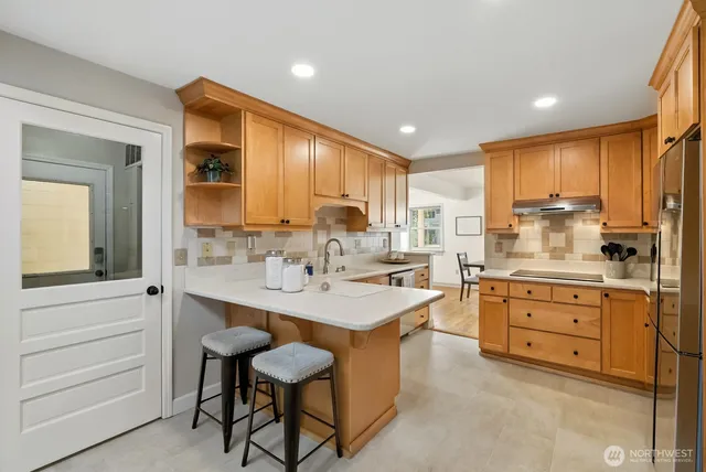 a kitchen with sink cabinets dining table and chairs