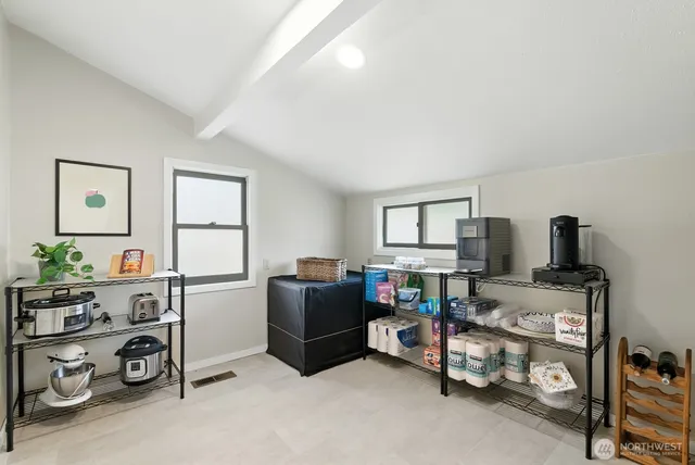 a room with furniture a flat screen tv and a window