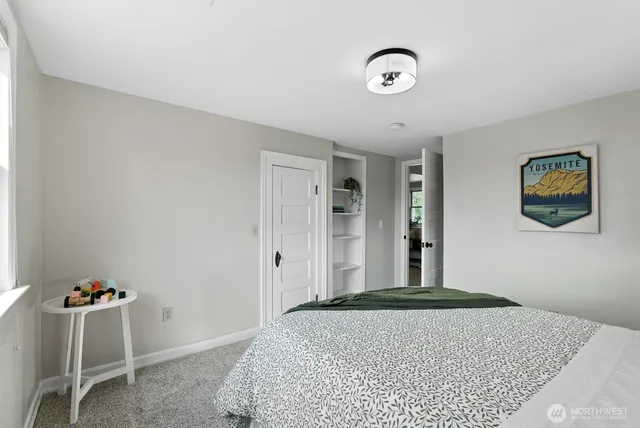 a bedroom with a bed and cabinets