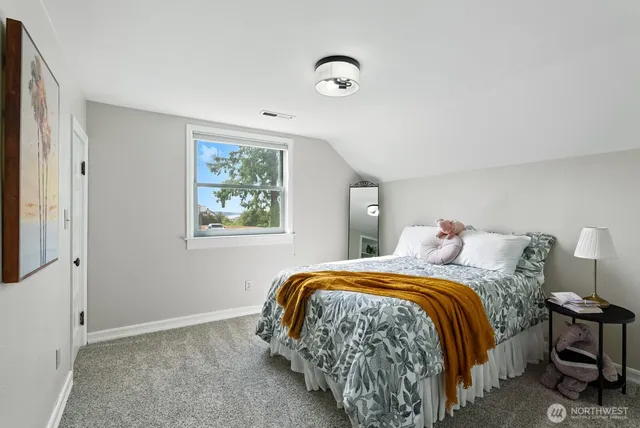 a bedroom with a bed and a window