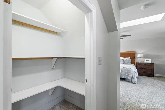 a bedroom with a bed and lamp