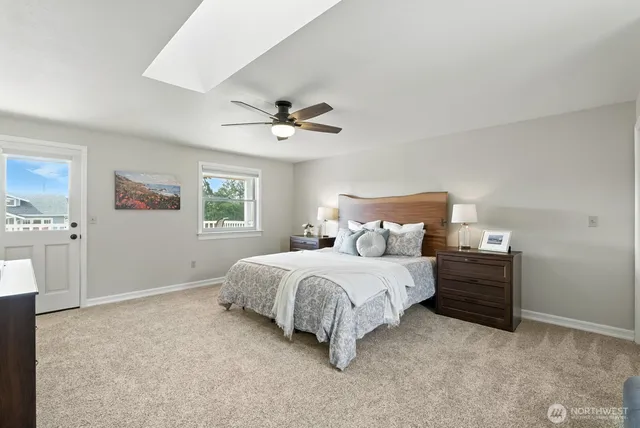 a spacious bedroom with a bed and a chandelier