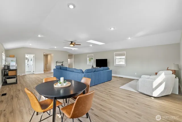 a living room with furniture kitchen view and a table