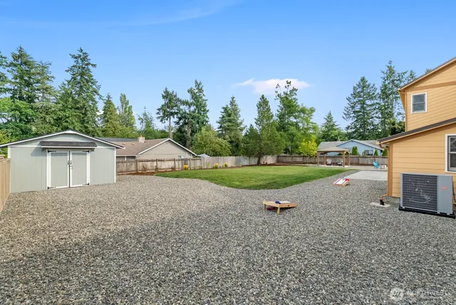 a view of a house with a yard and garage