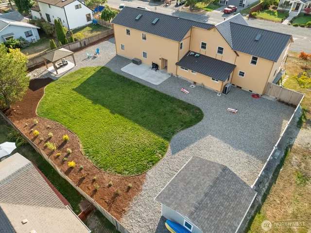 an aerial view of a house with a yard