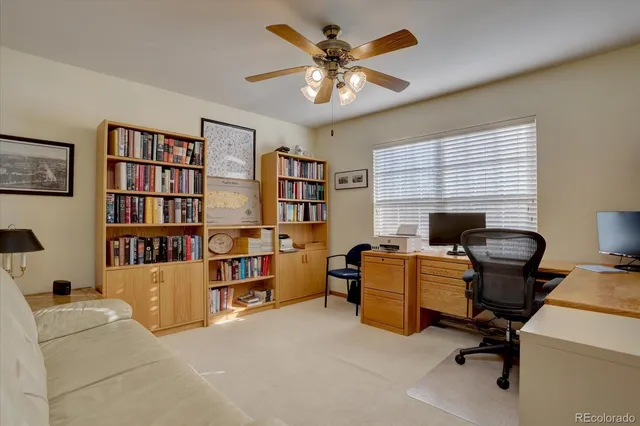 a view of a livingroom with workspace and a window