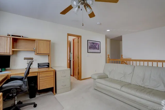 a bedroom with furniture and a ceiling fan