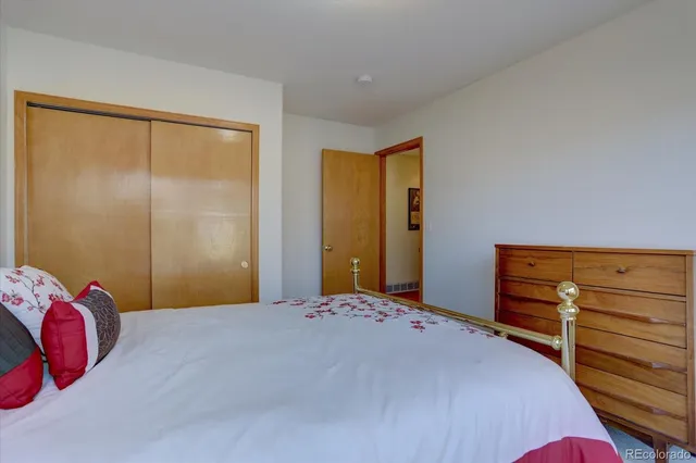 a bedroom with a bed and a cabinets