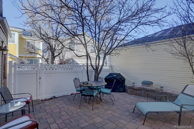 a view of a chairs and tables in the back yard of the house
