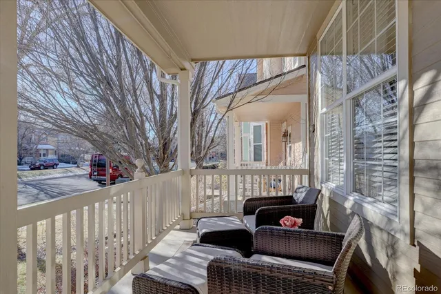 a view of a roof deck with furniture