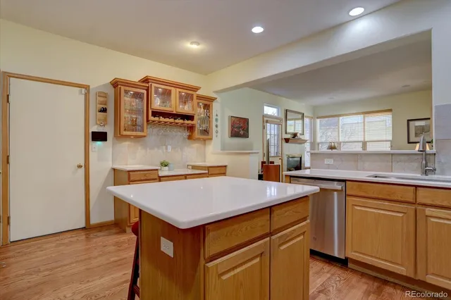 a kitchen with a sink a stove a refrigerator and white cabinets