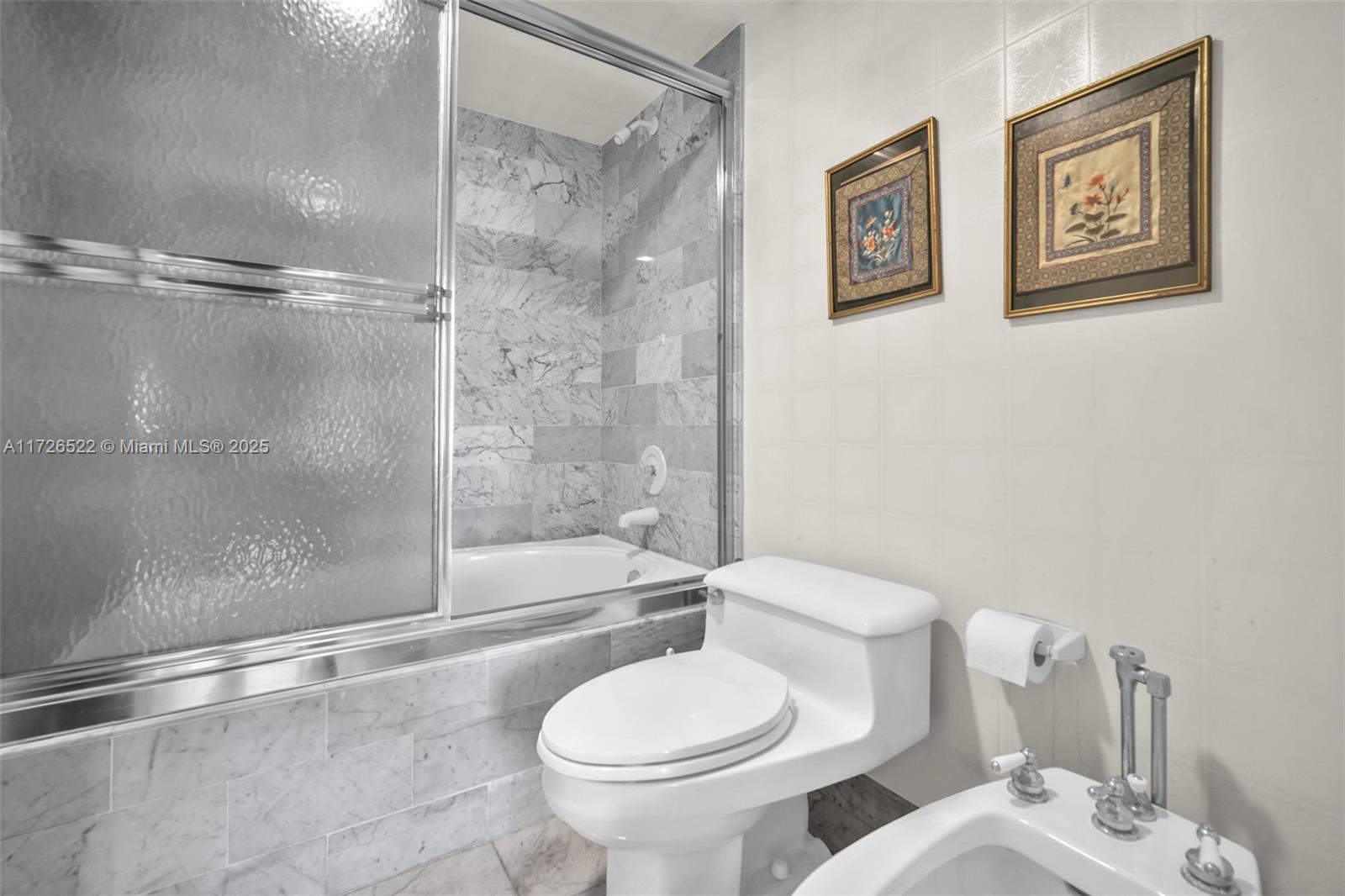 9341 Collins Avenue, Unit 1205 Surfside, FL 33154 - Photo 14 of 29 a white toilet sitting next to a bath tub and a shower