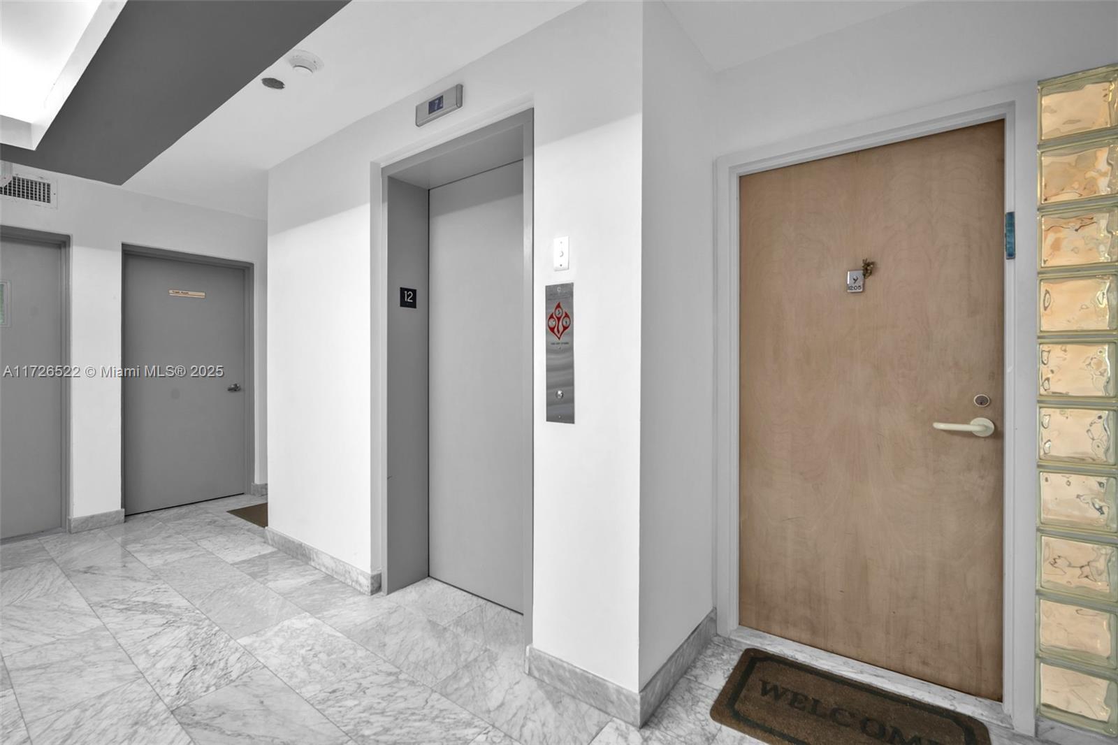 9341 Collins Avenue, Unit 1205 Surfside, FL 33154 - Photo 26 of 29 a view of a bathroom with a walk in closet and wooden floor