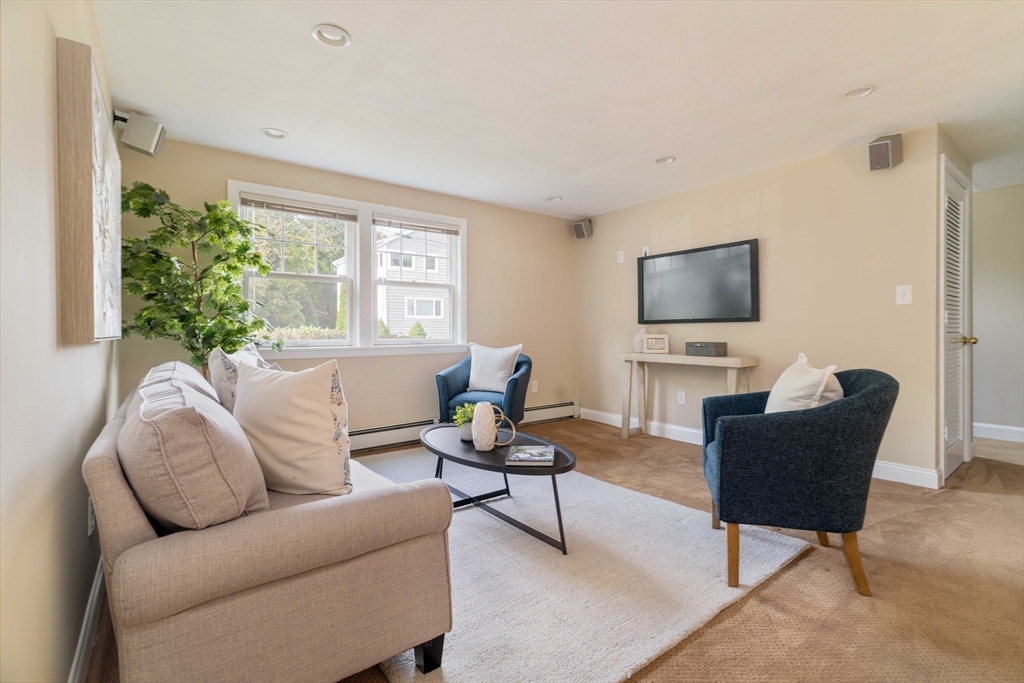 10 Hackensack Terrace Boston, MA 02467 - Photo 22 of 30 a living room with furniture a flat screen tv and a large window