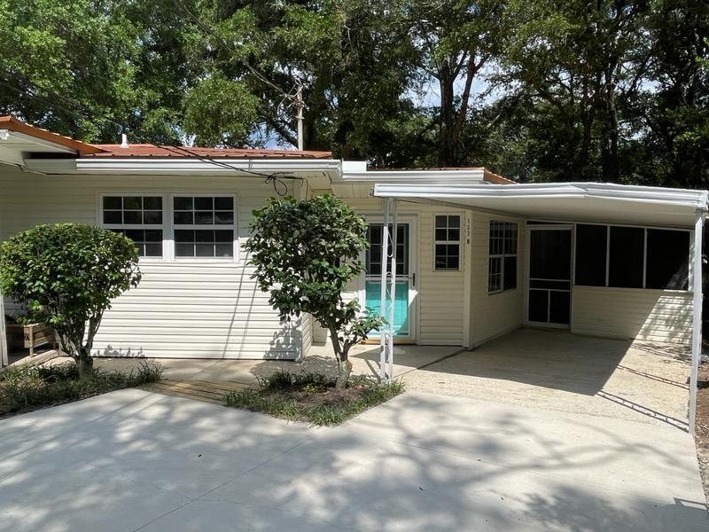 133 3rd Street, Unit B Niceville, FL 32578 - Photo 1 of 32 a view of a house with a yard and potted plants