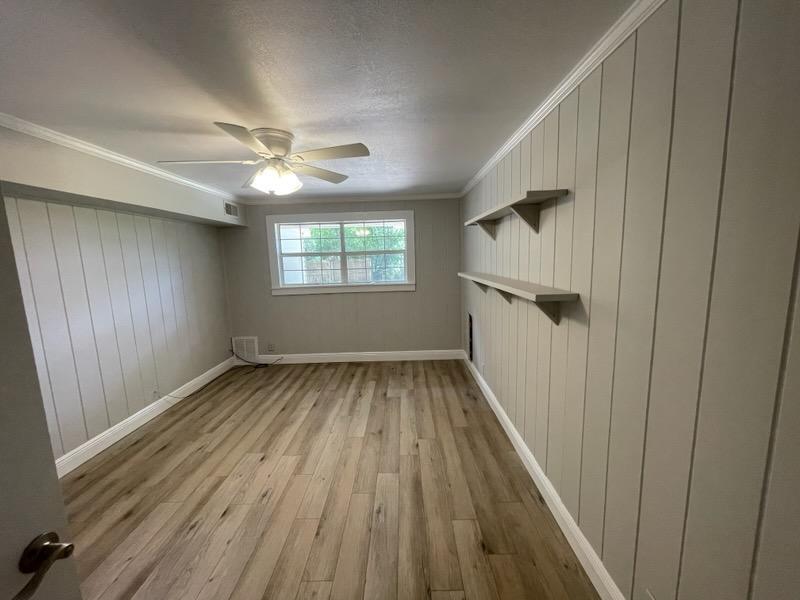 133 3rd Street, Unit B Niceville, FL 32578 - Photo 16 of 32 wooden floor in an empty room with a window