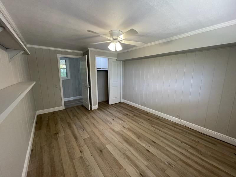 133 3rd Street, Unit B Niceville, FL 32578 - Photo 17 of 32 wooden floor in an empty room with a window