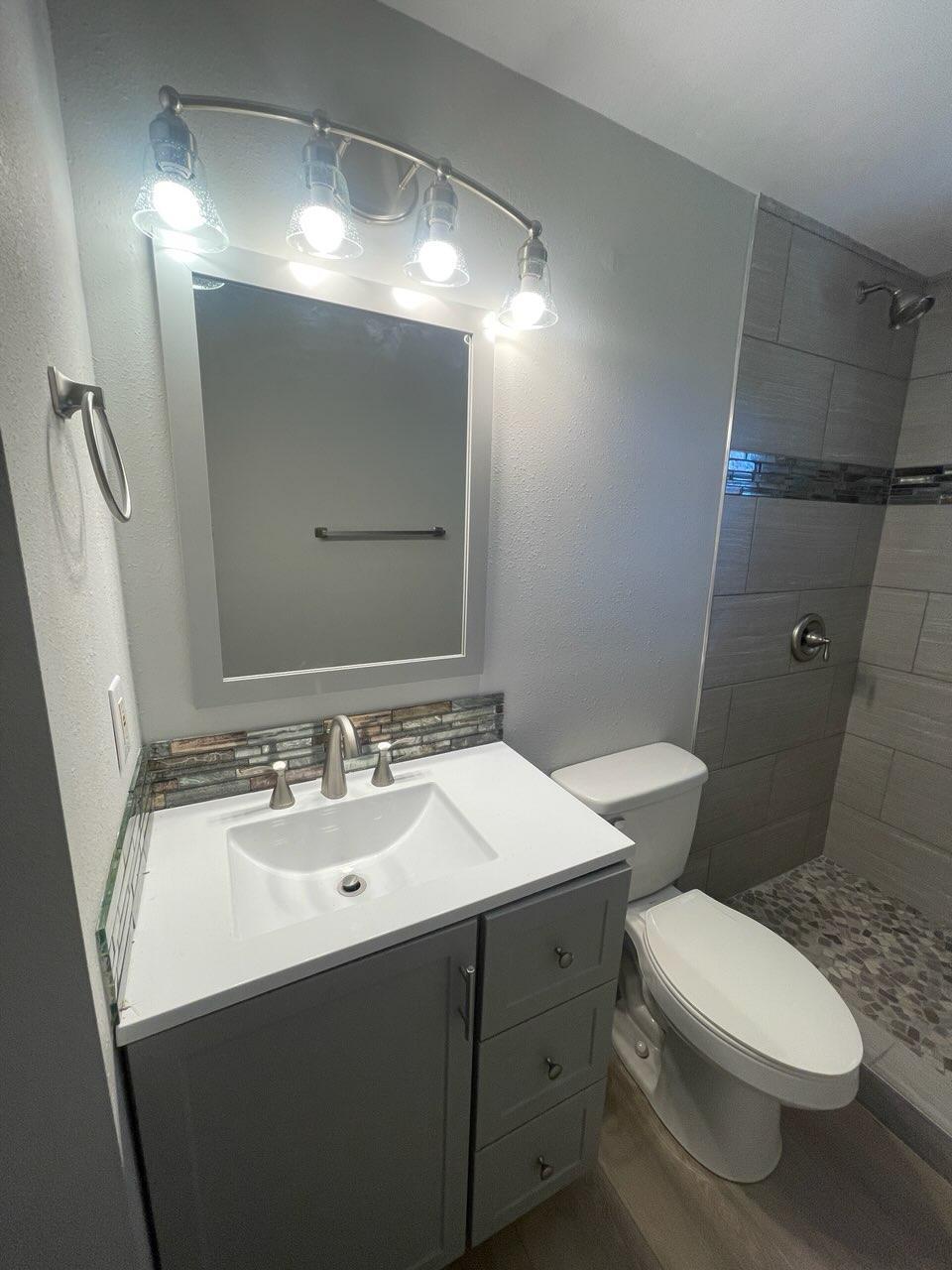 133 3rd Street, Unit B Niceville, FL 32578 - Photo 19 of 32 a bathroom with a sink and a mirror