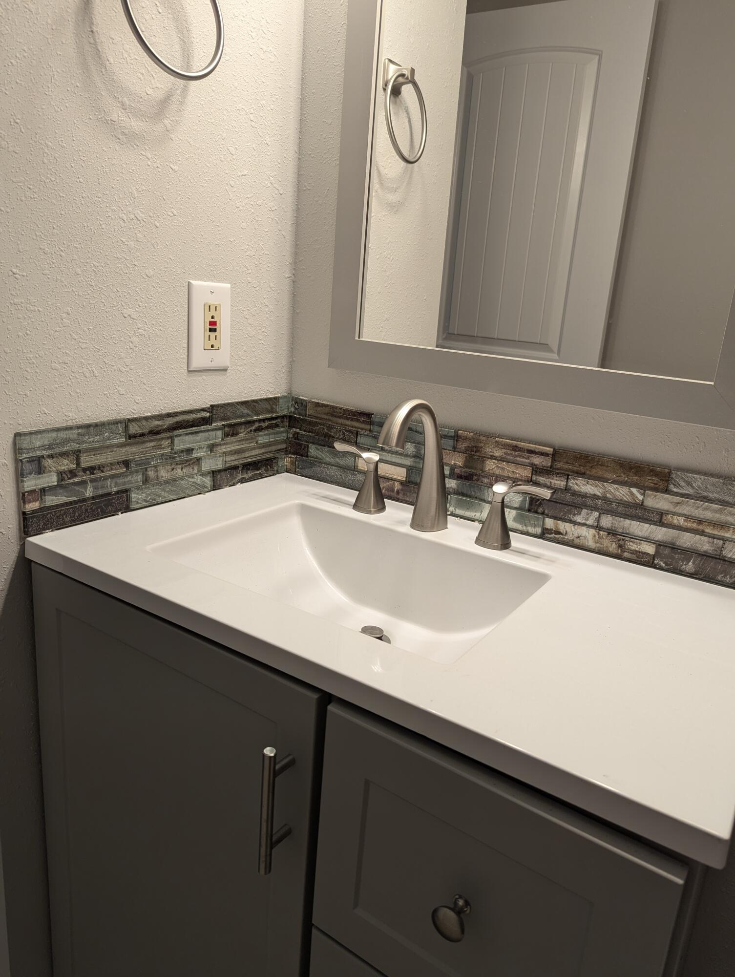 133 3rd Street, Unit B Niceville, FL 32578 - Photo 20 of 32 a bathroom with a sink and a mirror