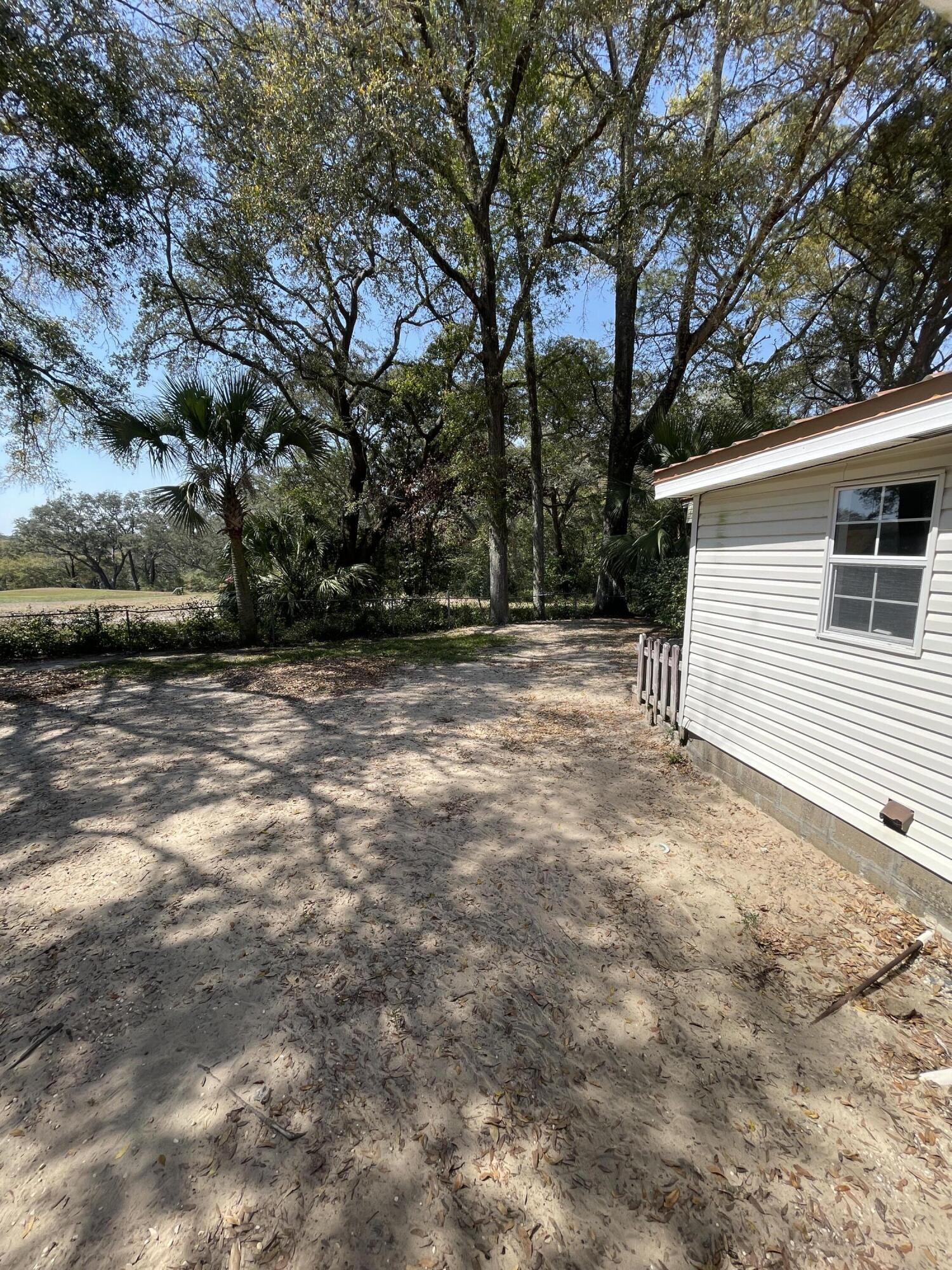 133 3rd Street, Unit B Niceville, FL 32578 - Photo 29 of 32 a backyard of a house with lots of green space