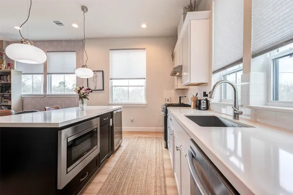 a kitchen with a sink stove and cabinets