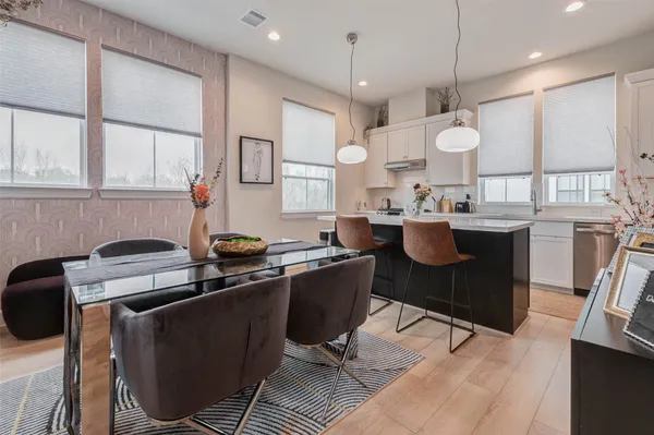 a kitchen with a table chairs stove and cabinets