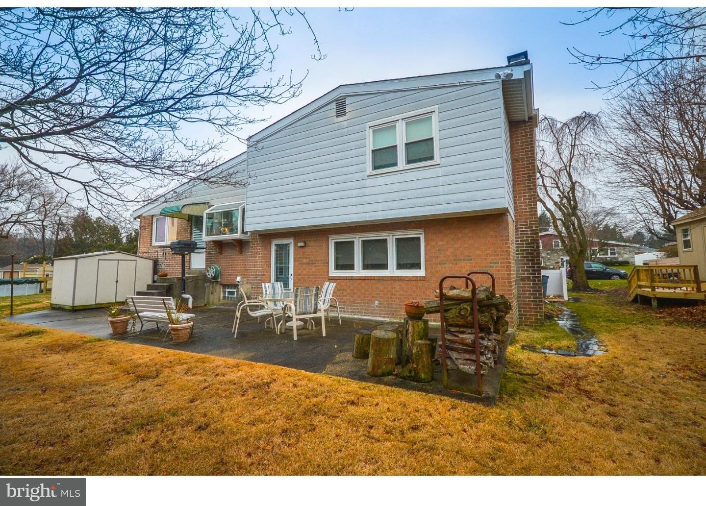 209 Radburn Road Philadelphia, PA 19115 - Photo 2 of 24 a backyard of a house with garden and outdoor seating