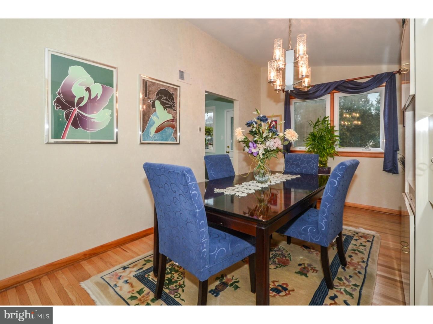 209 Radburn Road Philadelphia, PA 19115 - Photo 15 of 24 a view of a dining room with furniture a chandelier and wooden floor