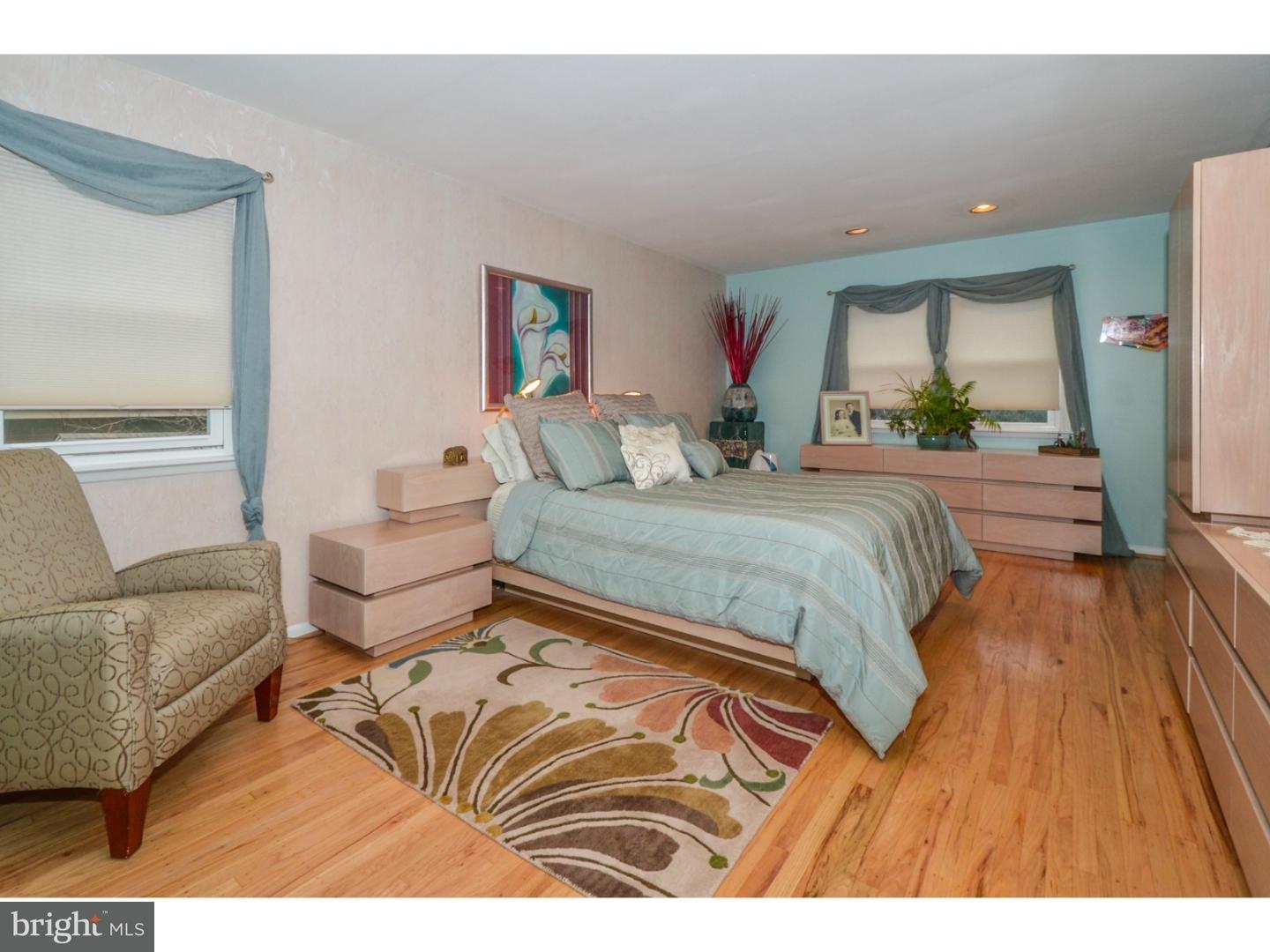 209 Radburn Road Philadelphia, PA 19115 - Photo 16 of 24 a bedroom with a bed and a large window