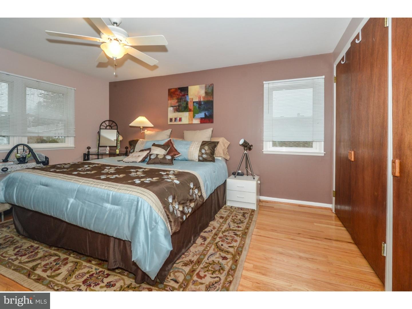209 Radburn Road Philadelphia, PA 19115 - Photo 19 of 24 a bedroom with a bed and a chandelier