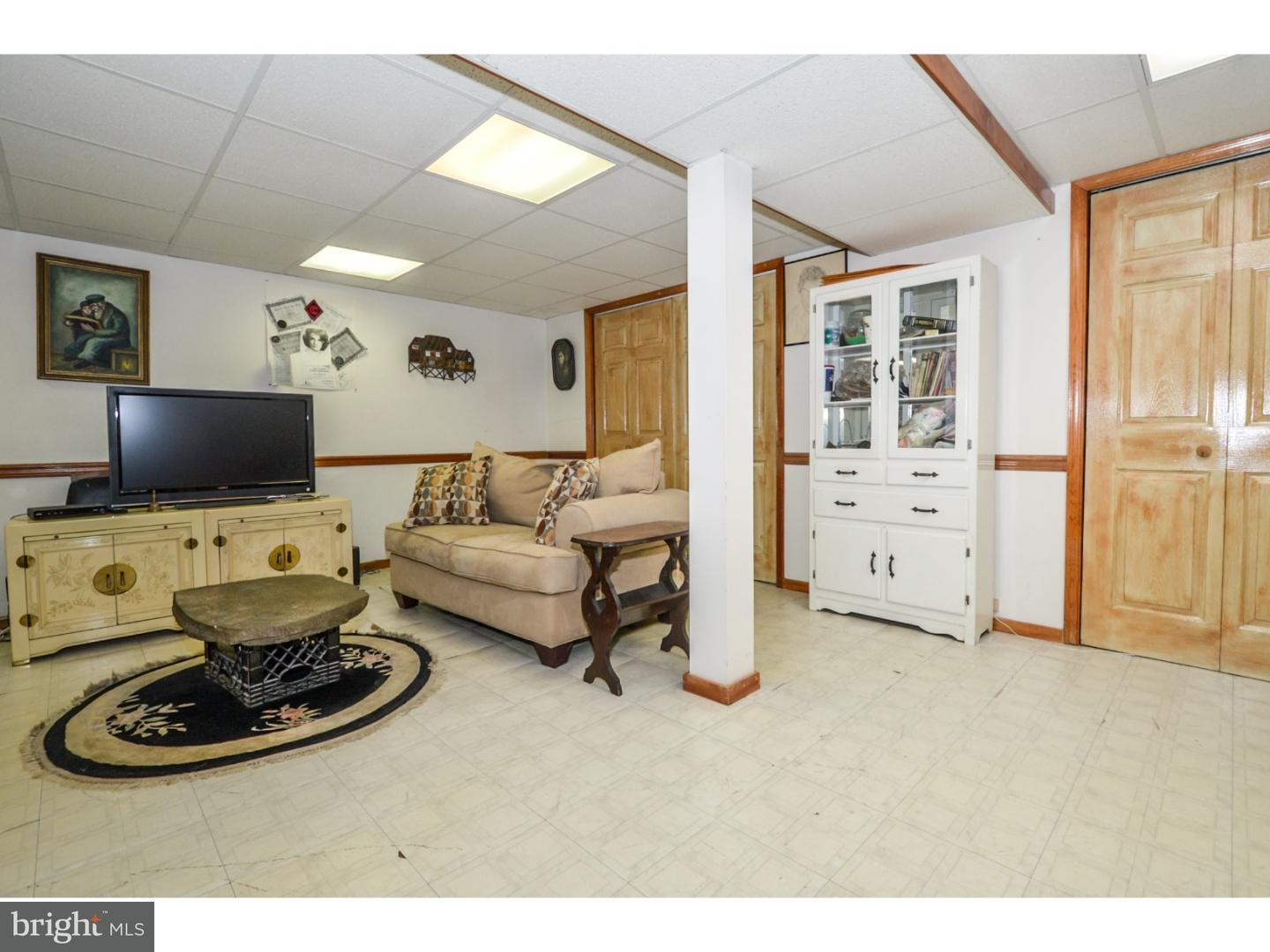 209 Radburn Road Philadelphia, PA 19115 - Photo 22 of 24 a living room with furniture and a flat screen tv