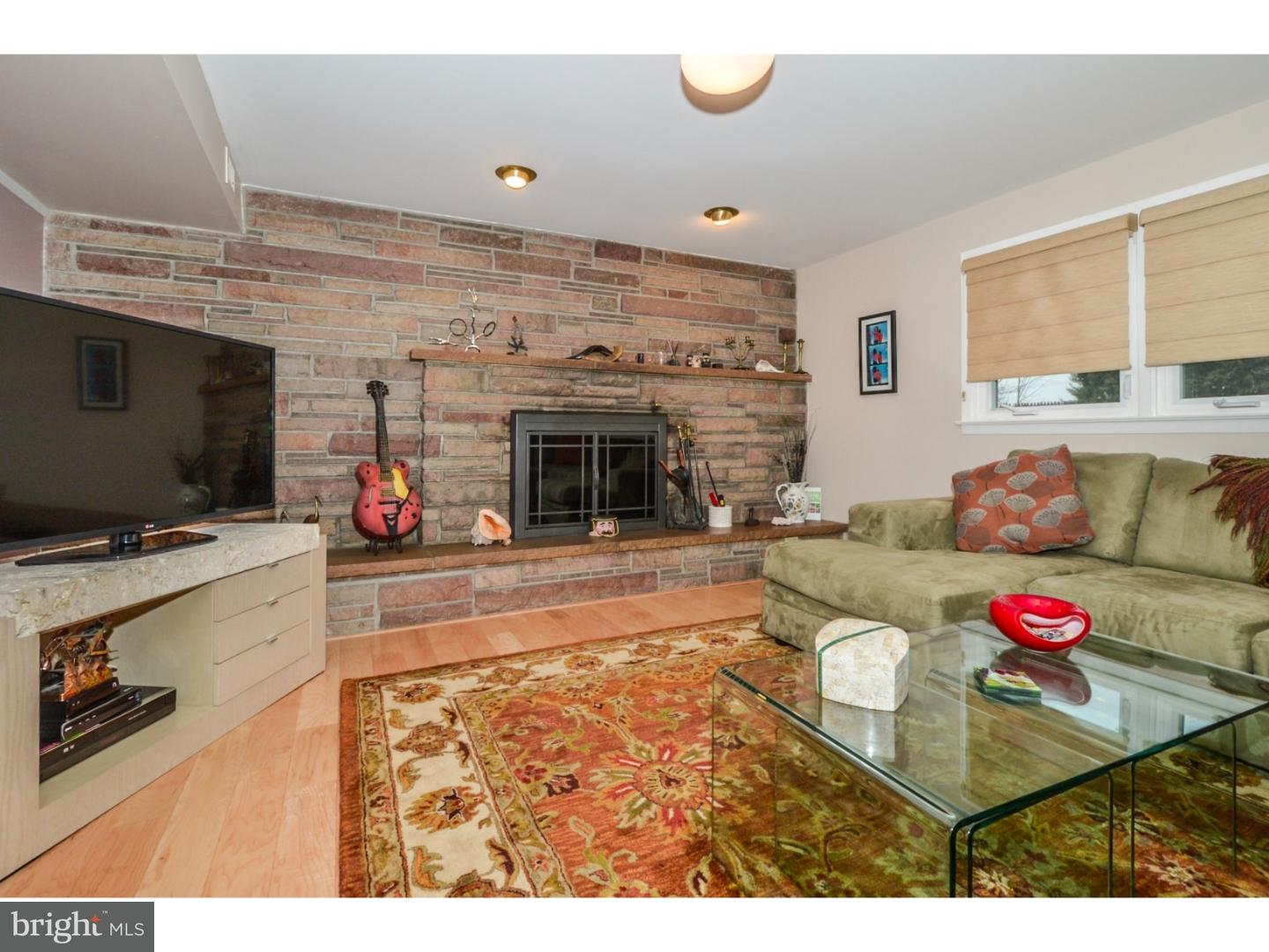 209 Radburn Road Philadelphia, PA 19115 - Photo 5 of 24 a living room with furniture and a flat screen tv