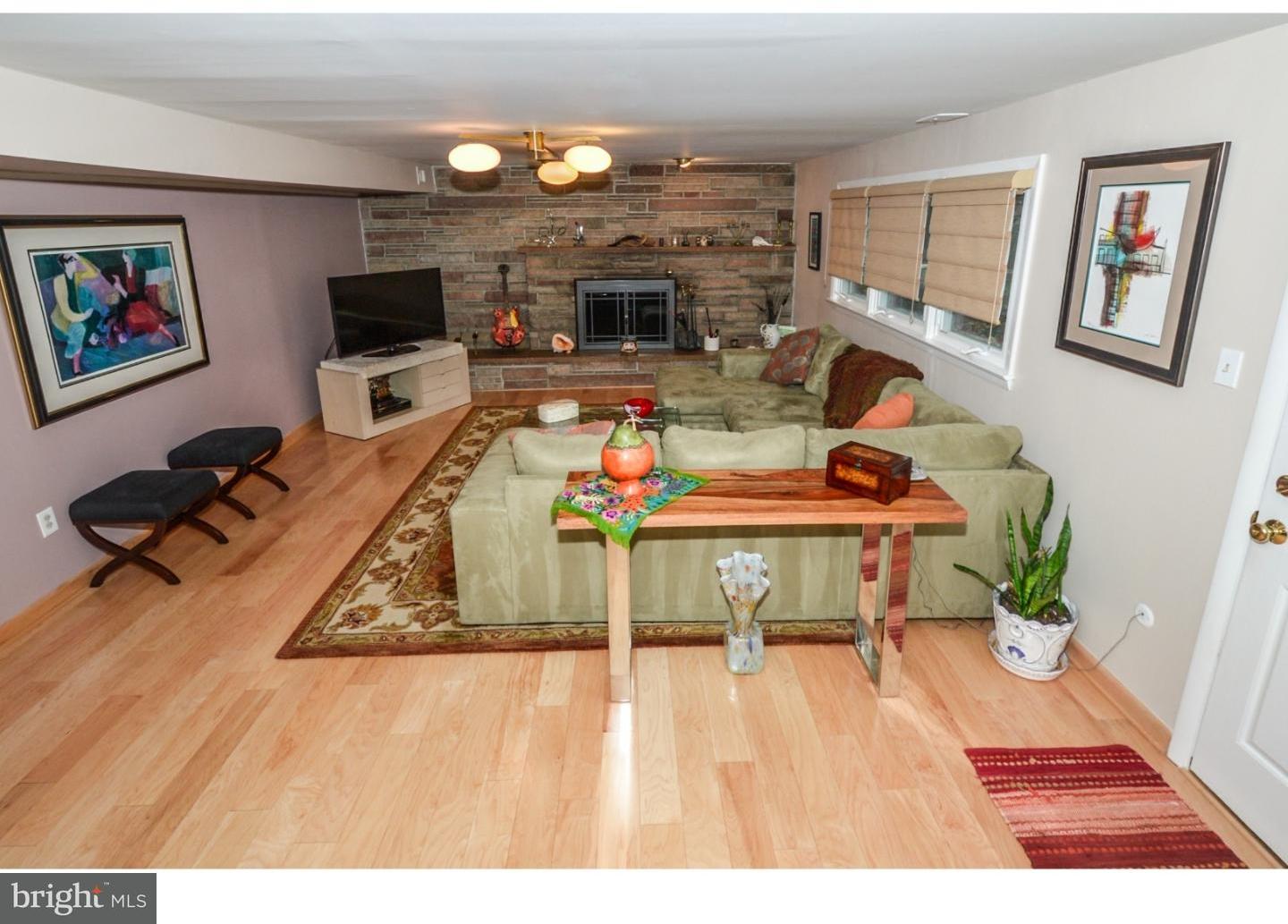 209 Radburn Road Philadelphia, PA 19115 - Photo 6 of 24 a living room with furniture and a flat screen tv