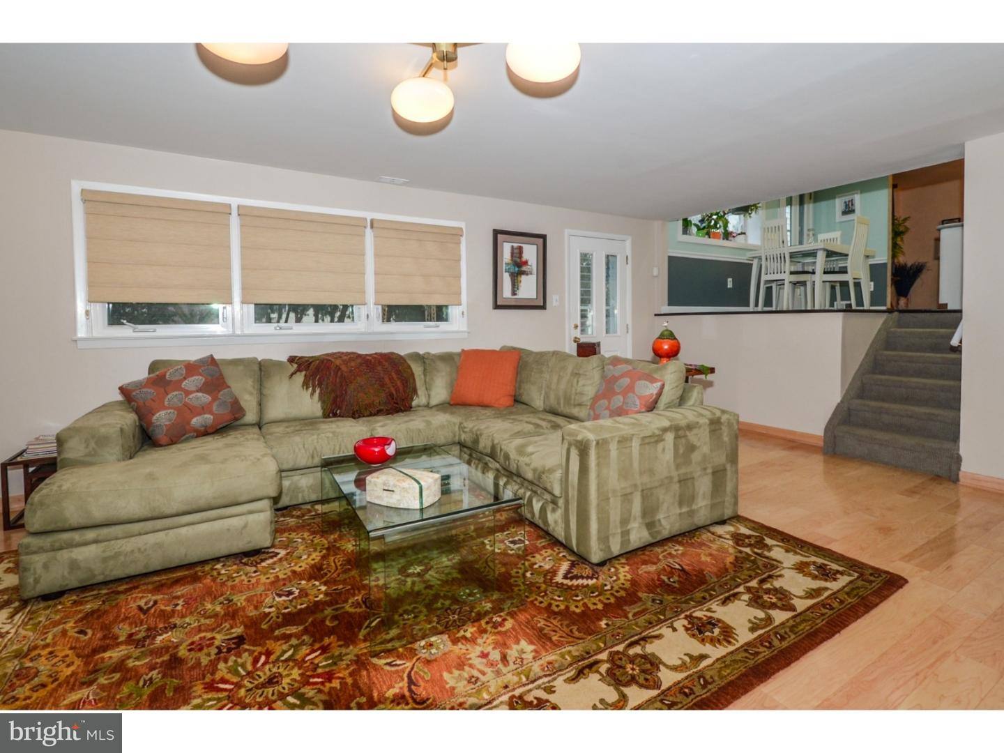 209 Radburn Road Philadelphia, PA 19115 - Photo 7 of 24 a living room with furniture and a flat screen tv