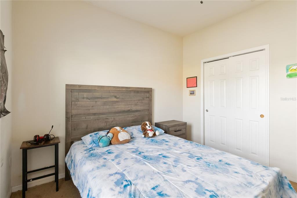 4042 Eternity Circle St. Cloud, FL 34772 - Photo 17 of 35 a bedroom with a bed and a dresser