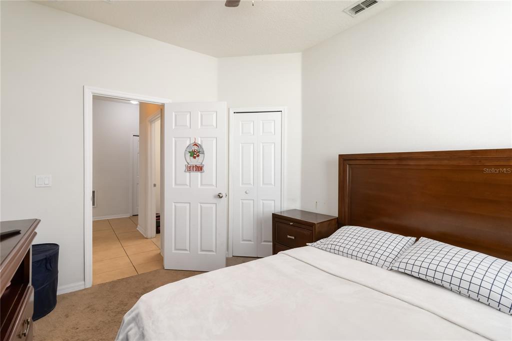 4042 Eternity Circle St. Cloud, FL 34772 - Photo 20 of 35 a bedroom with a bed and cabinets