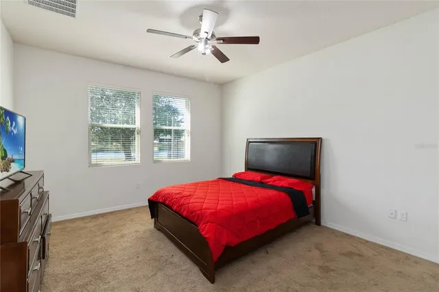 a bed sitting in a bedroom next to a window