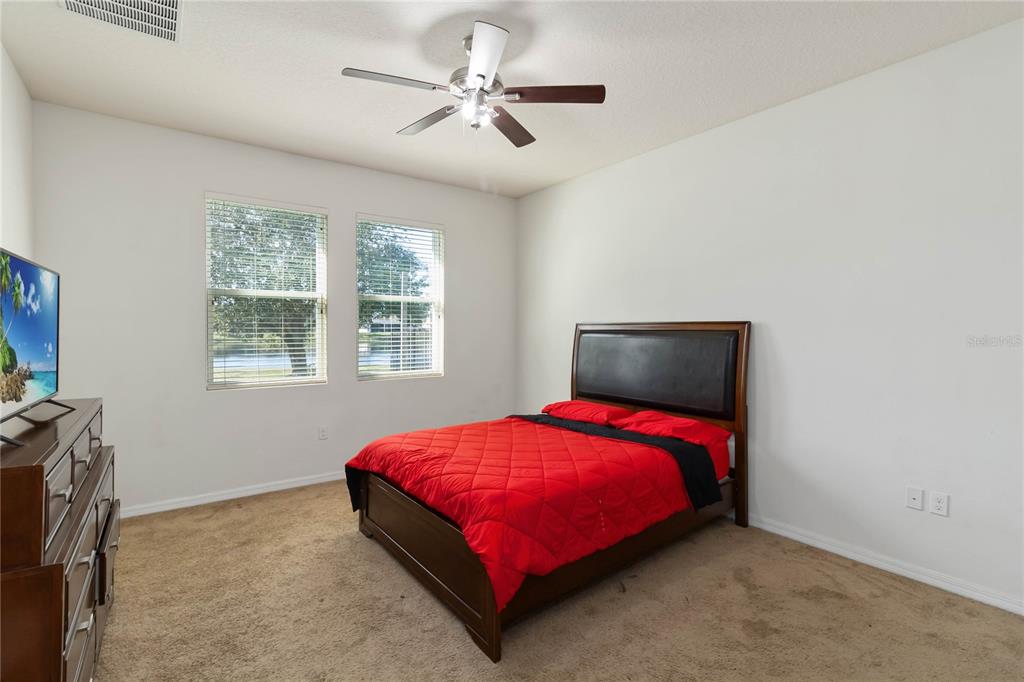 4042 Eternity Circle St. Cloud, FL 34772 - Photo 21 of 35 a bed sitting in a bedroom next to a window