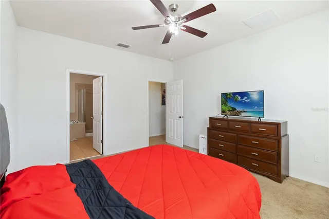 a bedroom with a bed and a dresser