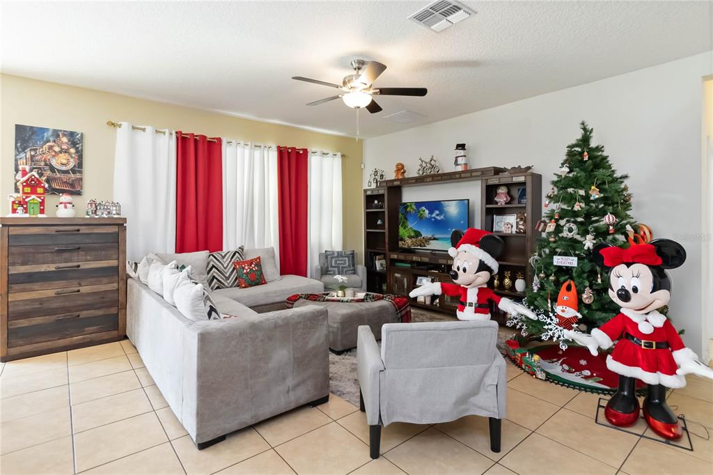 4042 Eternity Circle St. Cloud, FL 34772 - Photo 8 of 35 a living room with furniture and a potted plant
