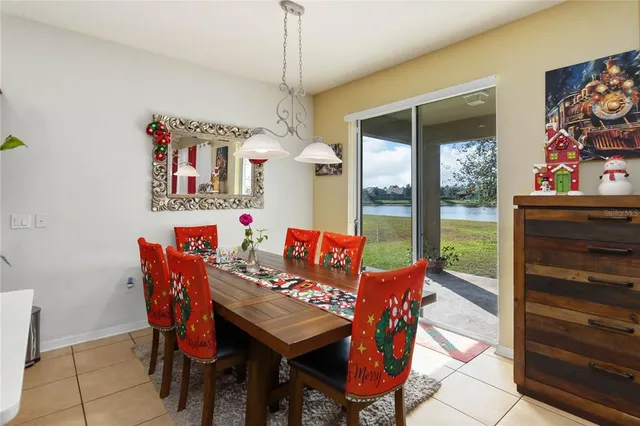 a view of a dining room with furniture a chandelier and a rug