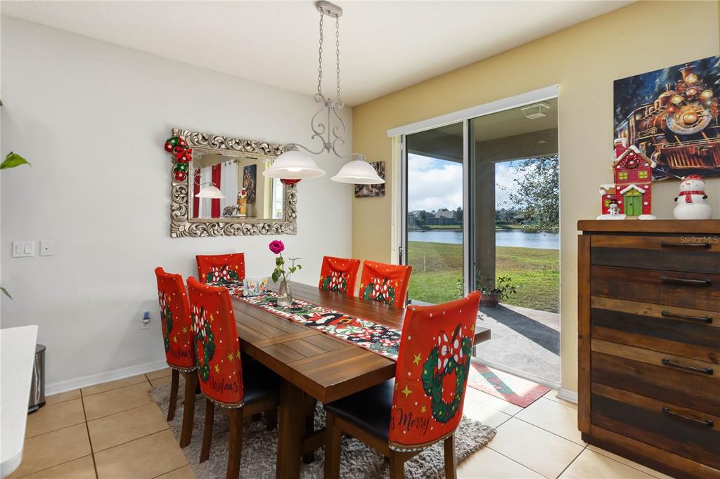 4042 Eternity Circle St. Cloud, FL 34772 - Photo 9 of 35 a view of a dining room with furniture a chandelier and a rug