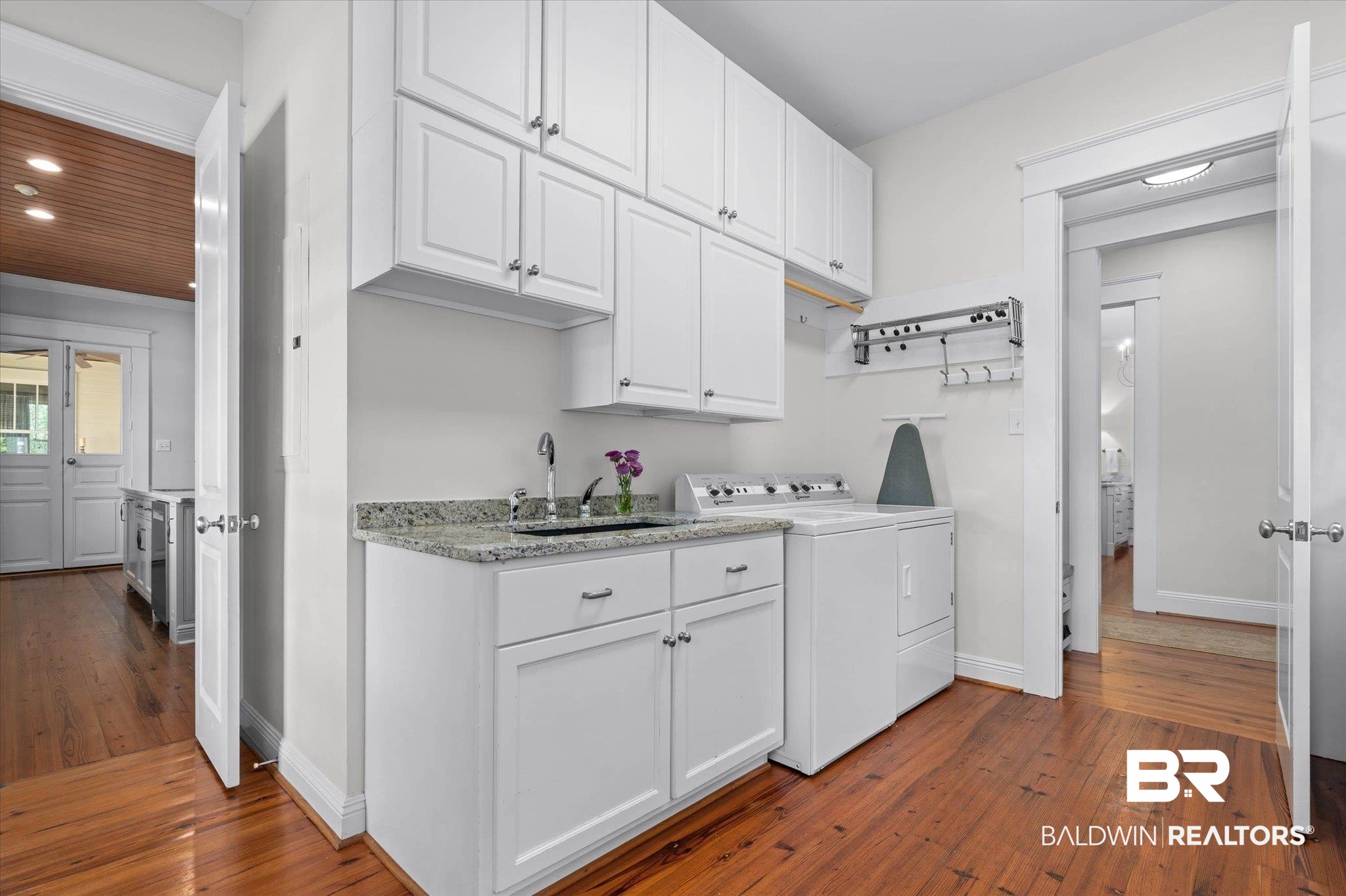 3813 Austill Lane Mobile, AL 36608 - Photo 10 of 37 Laundry room featuring white cabinetry, a utility sink with a stainless steel faucet, and a granite-finish countertop